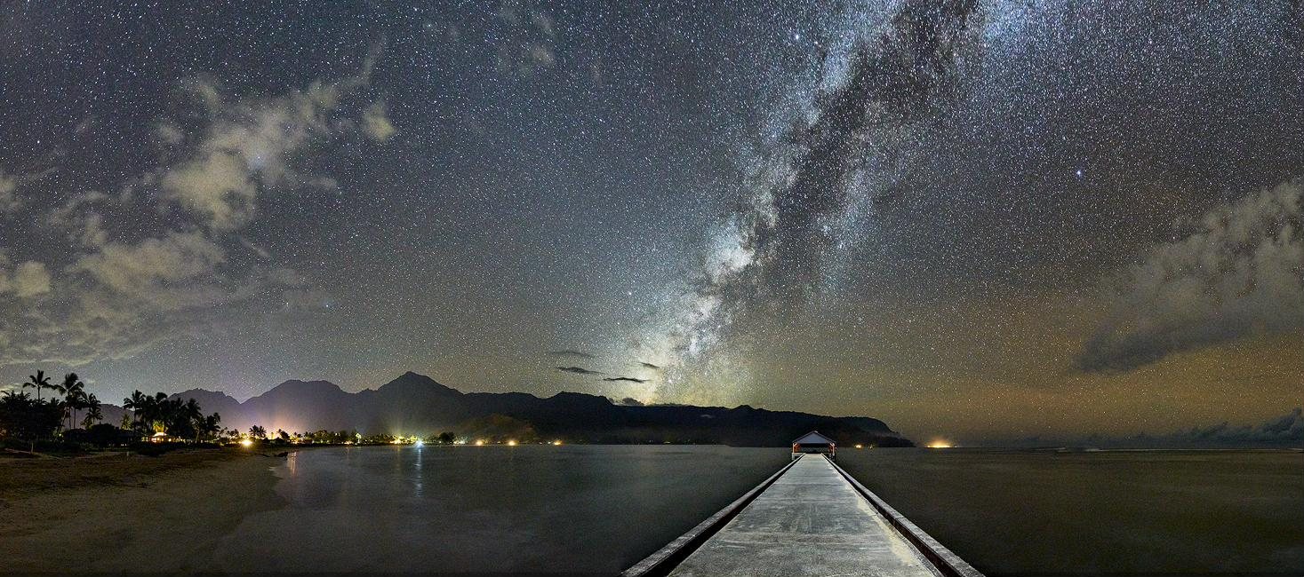 The Milky Way over Hanalei Bay, Kauaʻi, with the pier reaching into the water