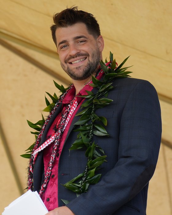 Grant Heath, founder of Amplify AI, smiling and wearing lei at a Kauaʻi ceremony